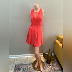 NEW BCBGeneration coral dress with lace cutouts and pleated skirt